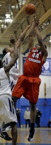 Homewood-Flossmoor's Maurius Hill shoots over Bloom Township's Nhyree Mitchell