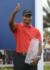 Woods keeps it dry and wins Players Championship