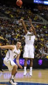 Michigan freshman and St. John native Glenn Robinson III shoots while teammate and Chesterton native Mitch McGary works for position