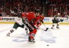 The Blackhawks' Andrew Shaw shoots against the Wild's Torrey Mitchell