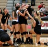 Lake Central players surround sophomore middle hitter Brooke Renner