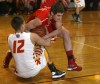 Andrean's J.J. Bosak, left, and Munster's Cody Gryzbowski grapple for possession of the basketball