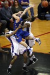 Merrillville's Isaiah Wilson draws the player control foul against Carmel's Michael Volovic on Saturday.