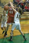 Hebron's Lauren Carlson is fouled by Kouts' Emma Leatherman 