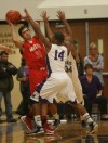 Munster's Cody Gryzbowski is double-teamed by Merrillville's Jalen Wilbert and Isaiah Wilson