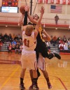 Hebron's Ryan Patz draws the charge from Kouts' Nick Taylor