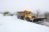 Snow plows work to clear the snow