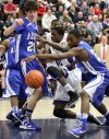 BBK_MC_REG_FINAL Merrillville's Jelani Pruitt works for a rebound at Merrillville's basket in the first half