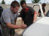 Lowell Body Shop owner Dave Hirata helps Lowell students