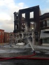Firefighters continue to douse hot spots in Whiting fire.