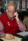 George Van Til works the phones and tallies numbers