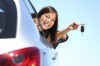 Driver woman showing new car keys