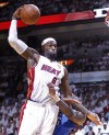 James' triple-double lifts Heat to NBA title