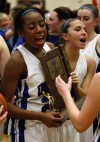Lake Central's Rolanda Curington, left, and Chrissy Addison carry the Class 4A Munster Sectional trophy off the floor Saturday night.