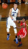 Lake Central's Mike Miklusak passes the ball as Morton's Devon Mingo applies defensive pressure Friday.