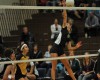 Illiana Christian's Tina Massey, right, spikes as Rachel Herrera looks on