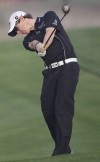 McIlroy's 65 takes lead in Dubai, Woods shoots 71