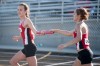 Portage freshman Kyra Ball hands off the baton to sophomore Rhyan Sloan during the second timed final of 400-meter relay at Tuesday's Chesterton Regional.
