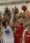 Lake Central's Mike Miklusak tries to stop Munster's Nate Bubash under the basket