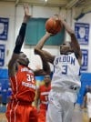 Homewood-Flossmoors Tai Odiase guards Bloom Township's Johnny Griffin