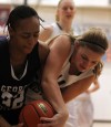Washington's Victoria Bradley and Illiana Christian's Megan Knapper fight for the ball