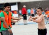 Eli Sandberg reaches for a drink in the Valparaiso Junior Triathlon on Saturday.