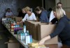 Volunteers pack Care Boxes for region families
