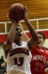 E.C. Central's Jeremiah Ochoa shoots around Munster's Drew Hachett 
