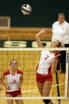 Crown Point's Alyssa Kvarta watches as teammate Meagan Fajman spikes