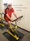 Jerry Stein on Indoor Cycle with Charles Schulz Wall Quote