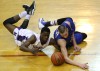 Merrillville's Jelani Pruitt and Carmel's Zach McRoberts fight for a loose ball Saturday.