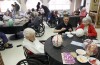 PNC students paint papier-mache eggs with seniors as part of service project