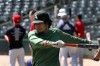 Aaron Nichols, of South Holland, stretches during RailCats open tryouts on Friday