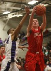 Munster's Pat McCarthy pulls down a rebound from Merrillville's Darion Williams