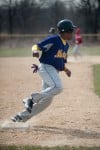 T.F. North's Michael Canty rounds third