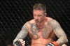 John Kolosci looks at his right hand 