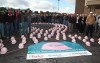 Workers don pink hard hats