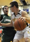 Kouts' Andy Lovall drives around the defense