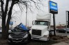 Semitractor rams into car dealership