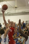 Munster's Nate Bubash puts up a shot against Lake Central