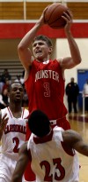 Munster's Mike Schlotman shoots over E.C. Central's Anthony Sells