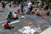 Kids paint the Crete Library parking lot