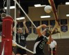 Tina Massey, center, goes up for a spike