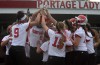 Portage's Kaitlin Doud (8) is mobbed at the plate following her solo home run in the Class 4A Portage Regional on Tuesday.