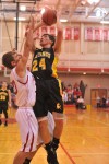 Kouts' Andrew Birky tries to power through a Hebron defender Friday night.