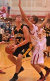 Kouts' Austin McNeil looks to score in the paint in the first quarter Friday night against Hebron.
