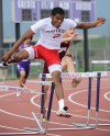 Portage's DeAndre Jackson jumps over a hurdle