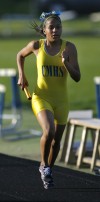 Crete-Monee junior Teja Foy runs the third leg of the 3,200 relay