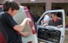 Lowell Body Shop owner Dave Hirata helps Lowell students
