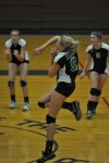 Sydnee VanBeek, center, spikes